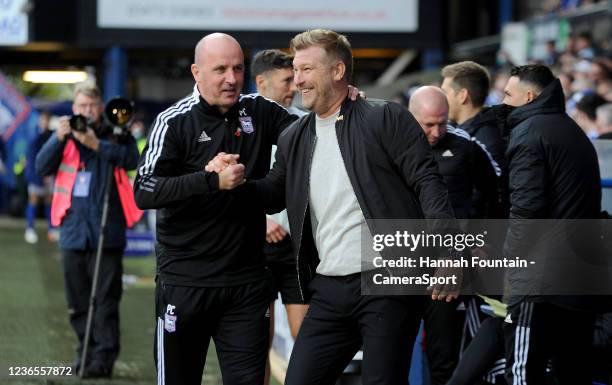 Ipswich Town manager Paul Cook and Oxford United manager Karl Robinson share a joke during the Sky Bet League One match between Ipswich Town and...