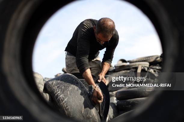 Syrian craftsman displaced from the city of Maarat al-Numan in the southern countryside of the Idlib province, recycles used tyres to be transformed...