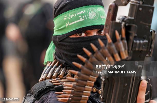 Member of Ezzedine al-Qassam Brigades, military wing of the Palestinian Hamas movement, takes part in a parade in Gaza City on November 14, 2021.