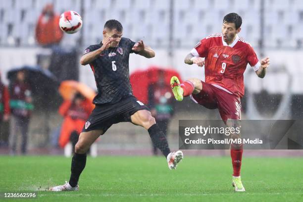 Fedor Smolov of Russia in action with Dejan Lovren of Croatia during the 2022 FIFA World Cup Qualifier match between Croatia and Russia at Stadium...