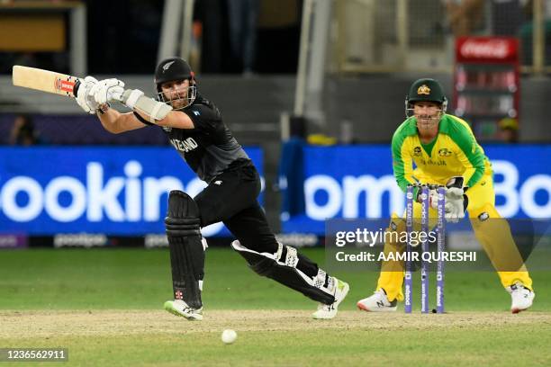 New Zealand's captain Kane Williamson plays a shot as Australia's wicketkeeper Matthew Wade watches during the ICC mens Twenty20 World Cup final...
