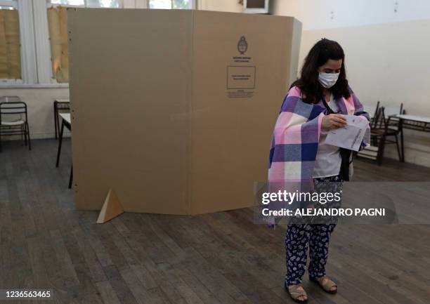 Woman prepares to cast her vote during mid-term parliamentary elections at a polling station in Buenos Aires, on November 14, 2021. - Argentines head...
