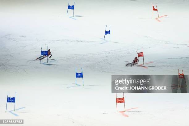 Austria's Dominik Raschner and Austria's Christian Hirschbuhl compete in the men's parallel slalom of the FIS ski alpine world cup in Lech, Austria...