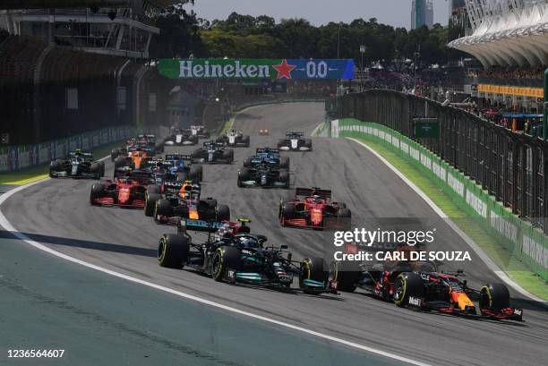 Red Bull's Dutch driver Max Verstappen and Mercedes' Finnish driver Valtteri Bottas power their cars during the start of Brazil's Formula One Sao...