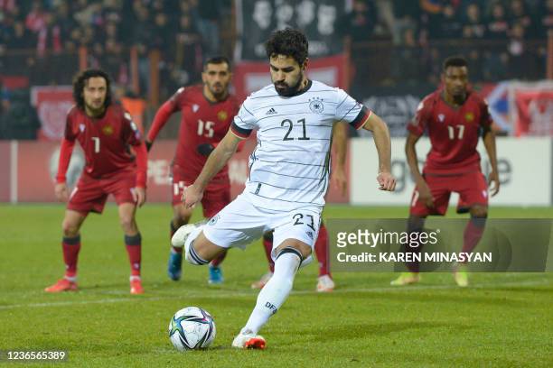Germany's midfielder Ilkay Gundogan shoots from the penalty spot to score the team's second goal during the FIFA World Cup Qatar 2022 qualification...
