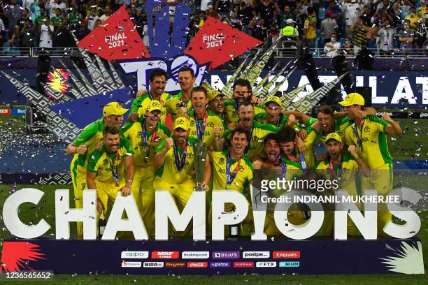 Australia's cricketers celebrate with their winning trophy at the end of the ICC men's Twenty20 World Cup final match between Australia and New...