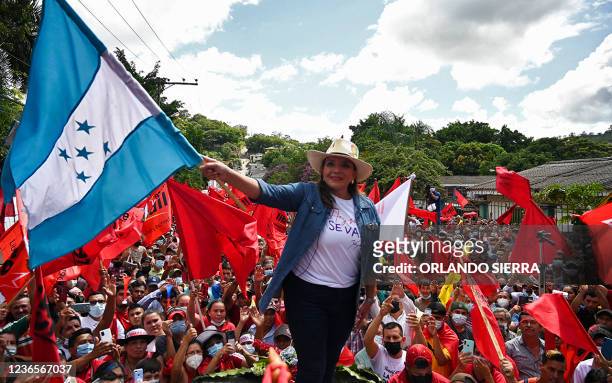 Honduran presidential candidate for the Libertad y Refundacion party Xiomara Castro de Zelaya flutters a Honduran flag during a rally in Santa...