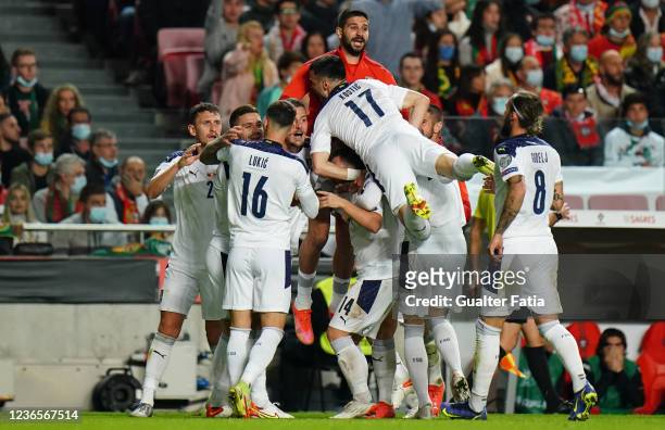 Dusan Tadic of Serbia celebrates with teammates after scoring a goal during the 2022 FIFA World Cup Qualifier match between Portugal and Serbia at...
