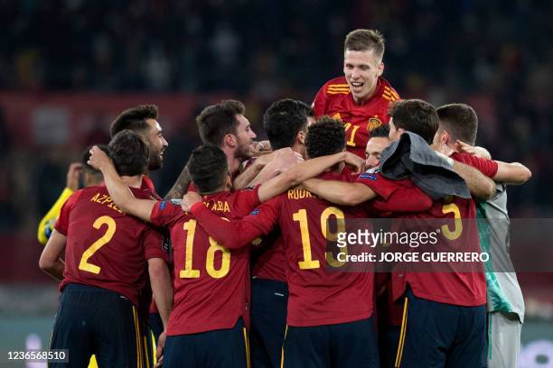 Spain's players celebrate after winning 1-0 the FIFA World Cup Qatar 2022 qualification group B football match between Spain and Sweden, at La...