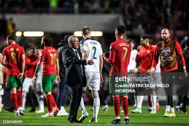 Portugal's coach Fernando Santos speaks with Portugal's forward Cristiano Ronaldo at the end of the FIFA World Cup Qatar 2022 qualification group A...