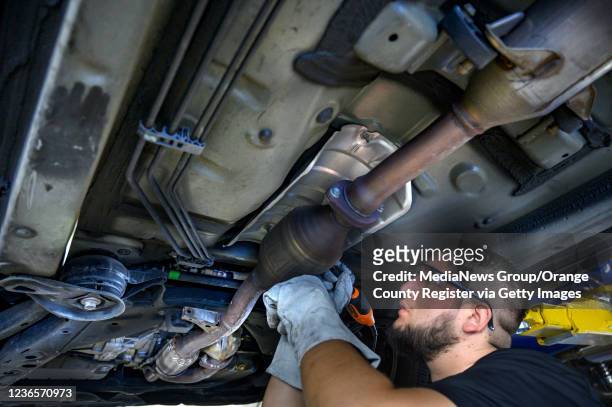 Huntington Beach, CA Huntington Beach, CA ExperTec Automotive technician Juan Martinez etches a catalytic converter with the cars license plate...