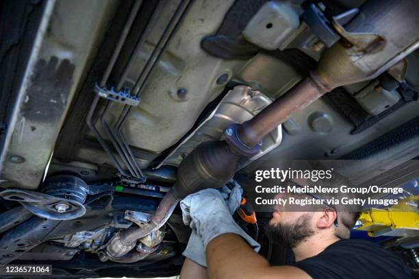 Huntington Beach, CA Huntington Beach, CA ExperTec Automotive technician Juan Martinez etches a catalytic converter with the cars license plate...