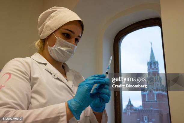 Health worker prepares a dose of the Sputnik V vaccine at a Covid-19 vaccination center inside the GUM luxury department store in Moscow, Russia, on...