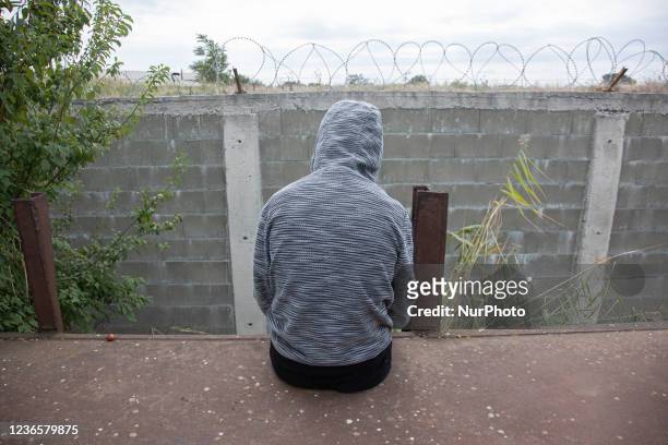 Afghan refugee who waiting for next train, sitting on a carriage in front of the barbed wire. Refugees and migrants are seen at the railway junction...