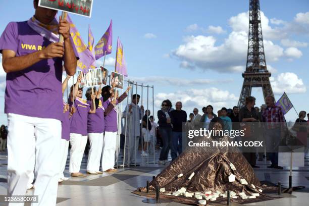 People take part in a demonstration on August 28, 2010 in front of the Eiffel tower at the Trocadero esplanade in Paris, in support to Sakineh...