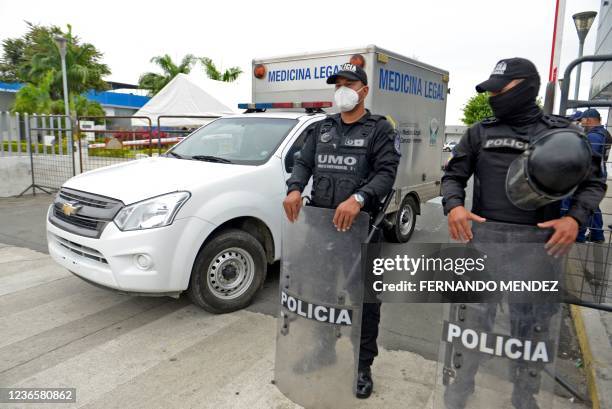 Graphic content / Police officers stand guard outside the police morgue as relatives of inmates wait for news of their loved ones, in Guayaquil,...