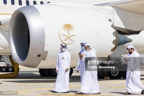 Attendees pass the engine of a Boeing 787-10 Dreamliner airliner, operated by Saudia Airlines, on static display at the 17th Dubai Air Show in Dubai,...