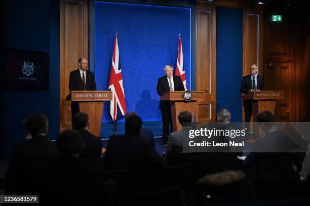 Prime Minister Boris Johnson stands between British Chief Medical Officer for England Chris Whitty and British Chief Scientific Adviser Patrick...