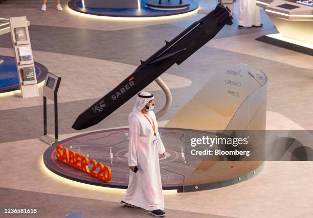 An attendee passes a model of a Saber 220 missile at the 17th Dubai Air Show in Dubai, United Arab Emirates, on Monday, Nov. 15, 2021. On the first...