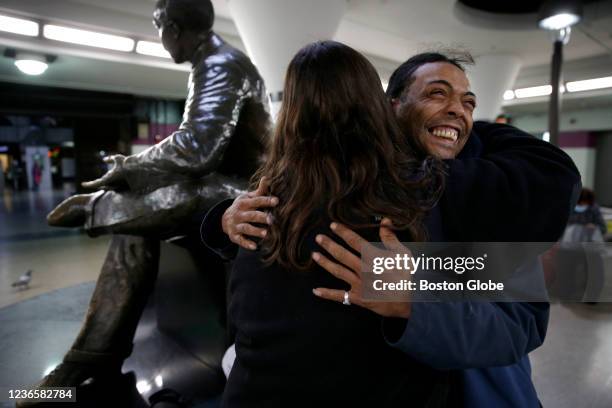 Lisa Loughlin, a chaplain who is part of 'Common Cathedral' an organization which has ecumenical services on Boston Common embraces Carlito Ortiz...