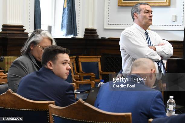 Kyle Rittenhouse waits with his defense team including lead attorney Mark Richards before closing arguments during his trial at the Kenosha County...