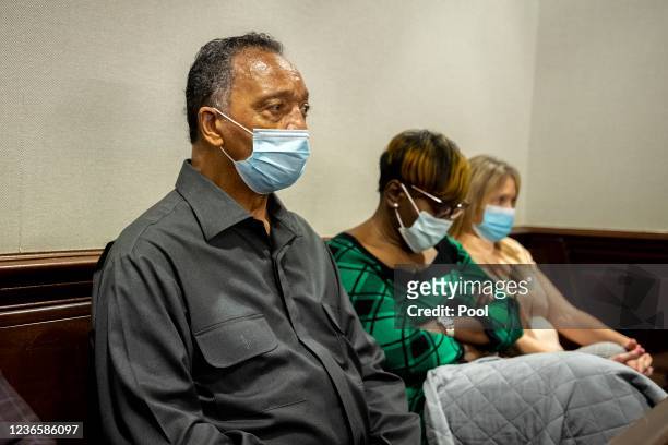 The Rev. Jesse Jackson, left, sits with Ahmaud Arbery's mother, Wanda Cooper-Jones, center, during the trial for Ahmaud Arbery's shooting death at...