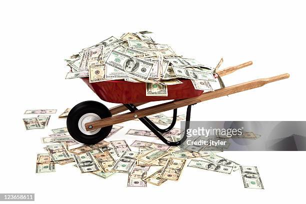 wheelbarrow full of money - money in wheelbarrow stockfoto's en -beelden