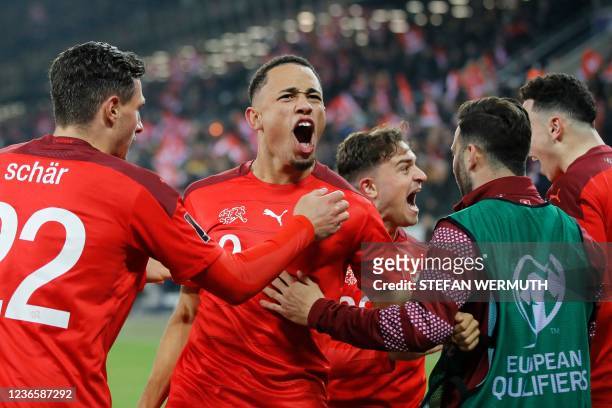 Swiss' midfielder Noah Okafor celebrates with team mates after scoring a goal during the FIFA 2022 World Cup qualifying group C football match...