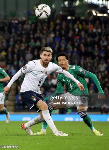 Italy's midfielder Jorginho vies with Northern Ireland's defender Jamal Lewis during the FIFA World Cup 2022 round one Group C qualification football...