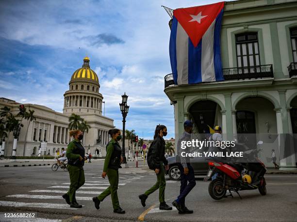 Police officers walk near Havana Capitol, on November 15, 2021. - The Cuban opposition has said it will take to the streets as planned on Monday to...