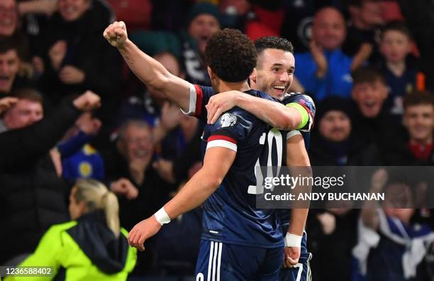 Scotland's striker Che Adams celebrates scoring his team's second goal with Scotland's midfielder John McGinn during the FIFA World Cup 2022 Group F...