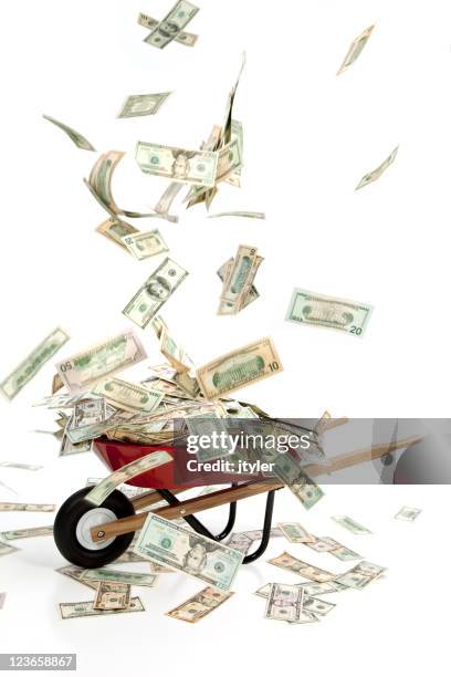 falling money - money in wheelbarrow stockfoto's en -beelden