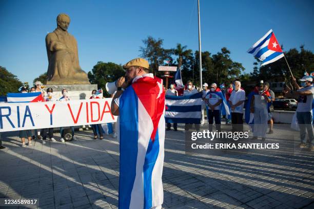 Group of Cubans living in the Dominican Republic demonstrate in support of the Cuban opposition in front of Jose Marti Park in Santo Domingo, on...
