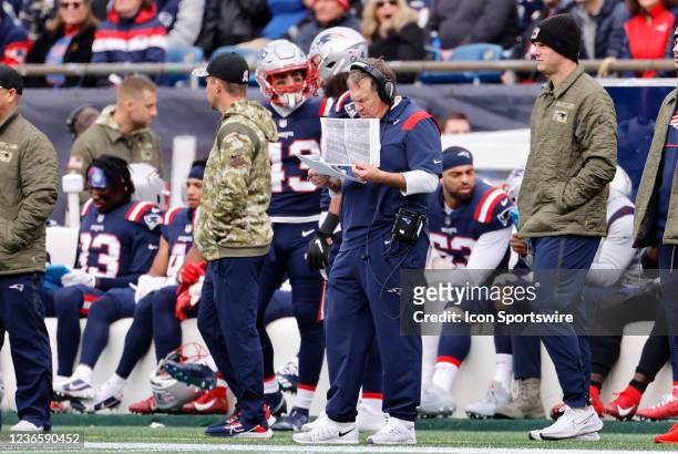 New England Patriots head coach Bill Belichick checks his notes