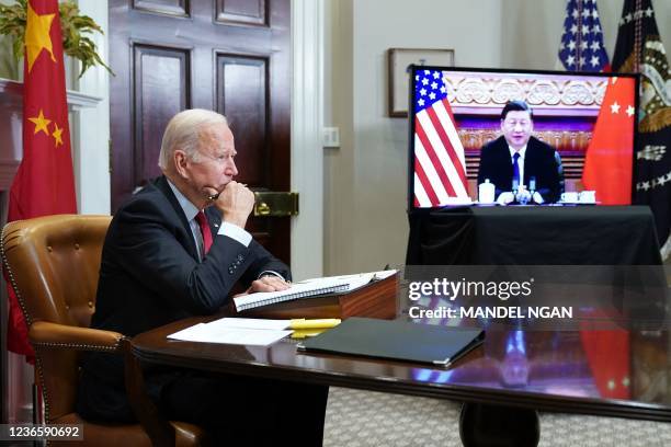 President Joe Biden meets with China's President Xi Jinping during a virtual summit from the Roosevelt Room of the White House in Washington, DC,...