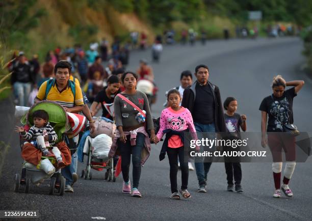 Migrants who were heading in a caravan to the US, walk in Palomares, Municipality of Matías Romero, Oaxaca State, Mexico, on November 15, 2021. - The...
