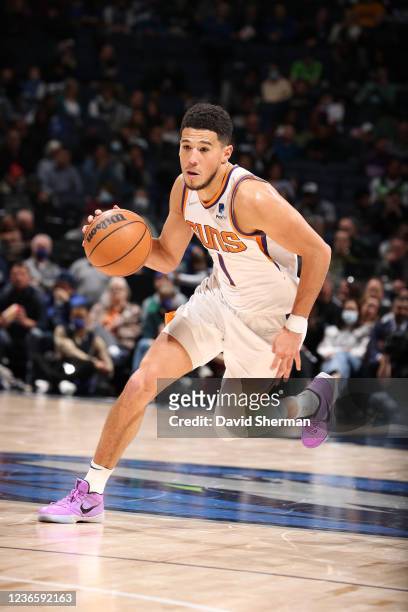 Devin Booker of the Phoenix Suns dribbles the ball against the Minnesota Timberwolves on November 15, 2021 at Target Center in Minneapolis,...