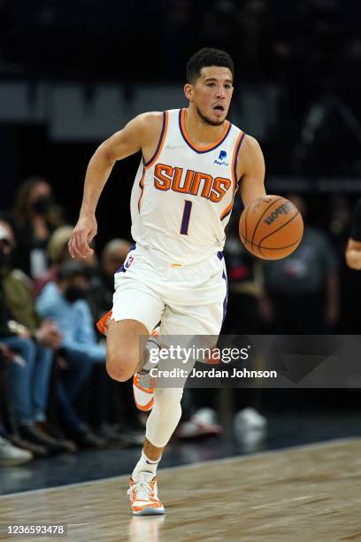 Devin Booker of the Phoenix Suns brings the ball up court against the Minnesota Timberwolves on November 15, 2021 at Target Center in Minneapolis,...