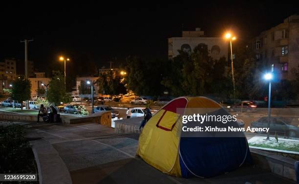 People stay in a tent after an earthquake in Bandar Abbas, southern Iran, Nov. 15, 2021. A 6.4-magnitude earthquake followed by an almost as intense...