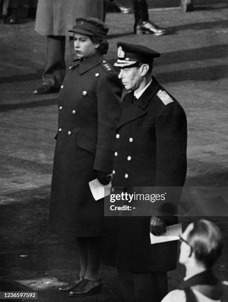 Princess Elizabeth of York and King George VI in ATS uniform stand at the Cenotaph during the first time armistice ceremony since 1938, on November...