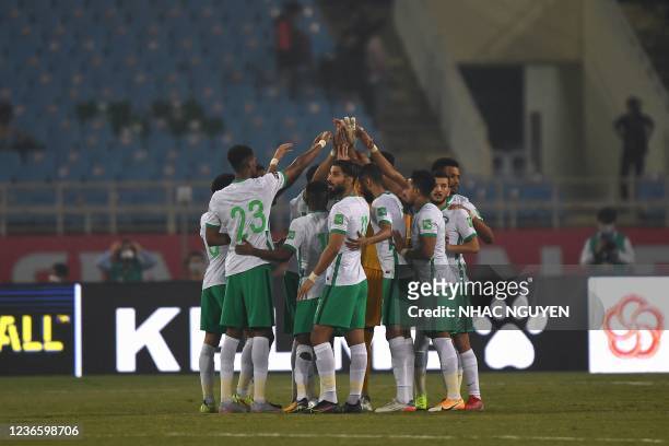 Saudi Arabia's players gather together before the start of the FIFA World Cup Qatar 2022 qualifying round Group B football match between Vietnam and...