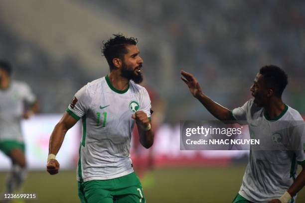 Saudi Arabia's forward Saleh al-Shehri reacts after scoring during the FIFA World Cup Qatar 2022 qualifying round Group B football match between...