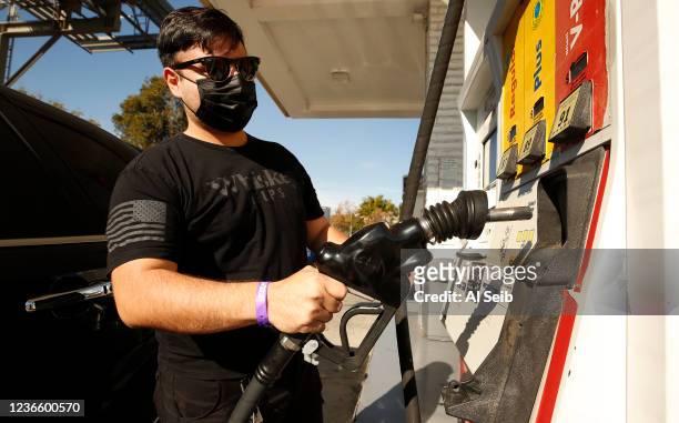 Peter Hernandez did a minor fill up as drivers select from various fuels priced near of above over $6 dollars at a Shell gas station located at South...
