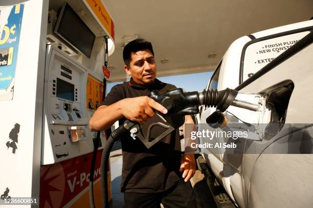 Alex Reyes began filling his work truck and stoped when he noticed the prices on the large marquee as drivers select from various fuels priced near...