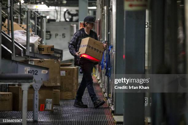 Ontario, CA Packages are being loaded into bins for delivery at the UPS West Coast Region Air Hub on Tuesday, Nov. 2, 2021 in Ontario, CA.