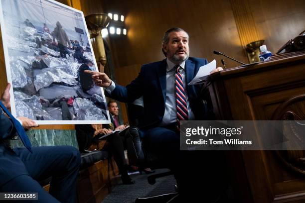 Sen. Ted Cruz, R-Texas, references a picture of migrants detained at the Mexican border while questioning DHS Secretary Alejandro Mayorkas, during...