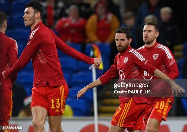 Wales' midfielder Kieffer Moore , Wales' midfielder Joe Allen , and Wales' midfielder Aaron Ramsey warms up ahead of the FIFA World Cup 2022 Group E...