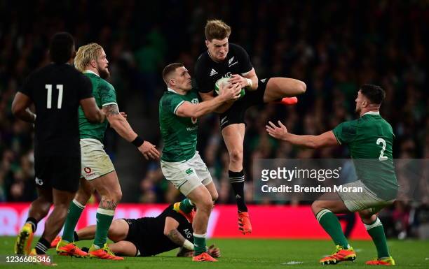 Dublin , Ireland - 13 November 2021; Jordie Barrett of New Zealand is tackled by Andrew Conway of Ireland during the Autumn Nations Series match...