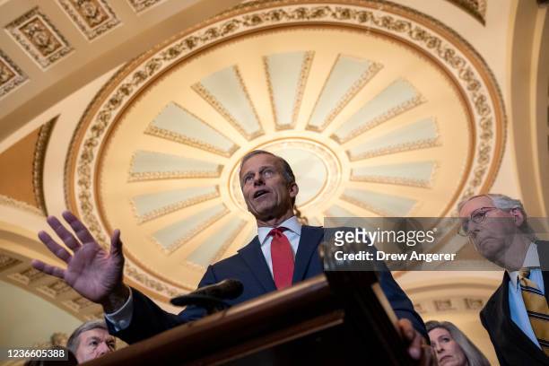 Sen. John Thune speaks as Senate Minority Leader Mitch McConnell looks on during a news conference after a lunch meeting with Senate Republicans at...