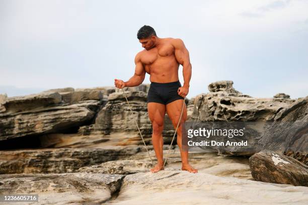 Chris Kavvalos does some resistance exercises with a rope during an early morning photo shoot at Little Bay on May 31, 2020 in Sydney, Australia....